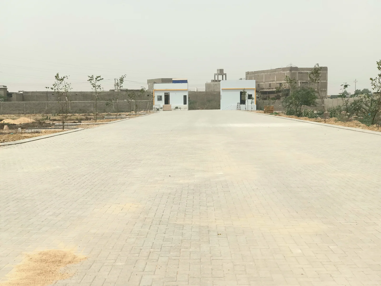 A broad paved approach at Jannat City